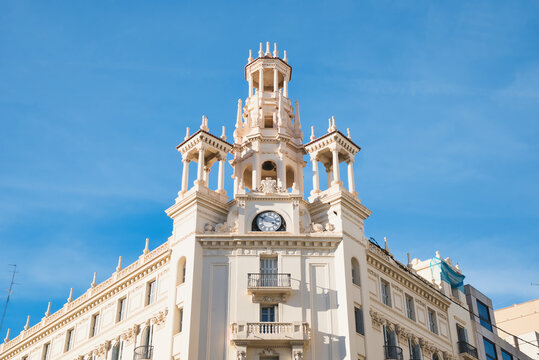 Old building with clock and tower magnificent building Casa del Chavo in Valencia, Spain. Ornate architecture, historical monument, city center, Spanish heritage. 
