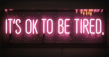 Bright pink neon sign displays text. Dark background emphasizes glowing message, offering comfort, positivity. Simple, direct statement.