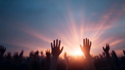People raising hands in prayer during sunset. Christian worship service outdoors with sky in background. Spiritual event for religious community.