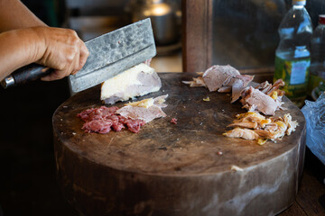 Vietnamese pho bo beef cutting on wooden chopping board