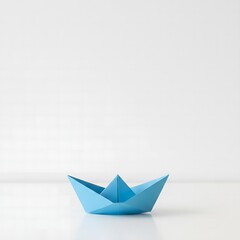 blue origami paper boat on white background with copy space