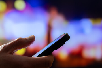 Smartphone In Hand At Night With City Bokeh, Mobile Texting And Browsing For Online Communication, Social Media Scrolling And Urban Lifestyle