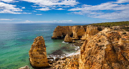 Natural caves at Marinha beach, Algarve Portugal. Rock cliff arches on Marinha beach and turquoise sea water on coast of Portugal in Algarve region. © daliu
