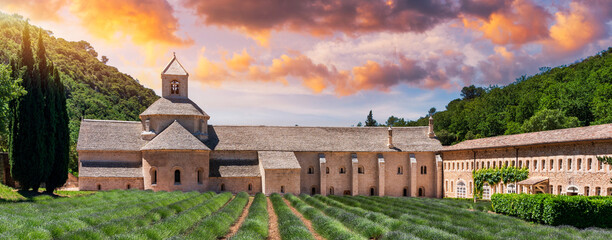 Romanesque Cistercian Abbey of Notre Dame of Senanque set amongst flowering lavender fields, near Gordes, Provence, France. Abbaye Notre-Dame de Senanque Romanesque Cistercian Abbey, Provence, France.