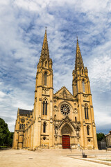 Fototapeta premium Eglise Saint-Baudile de Nimes church in Nimes, Gard, France. Eglise Saint-Baudile de Nimes church in Nimes showcasing striking architecture against a dramatic sky in Gard, France.