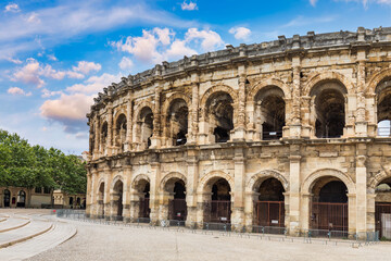 Fototapeta premium This historic Roman amphitheater in Nimes showcases ancient architecture. Historic Roman amphitheater in Nimes, Gard, France with beautiful sky. Nimes, Gard, France.