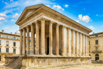 Obraz premium Historic Maison Carrée, a well-preserved ancient Roman temple in Nimes, Gard, France. Visit to the ancient Maison Carrée temple in Nimes, Gard, France during a sunny day. Nimes, Gard, France.