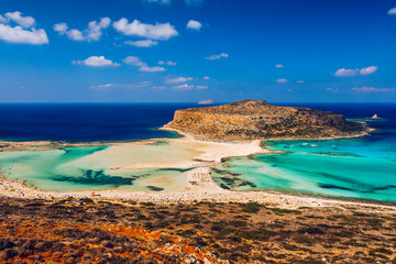 Fantastic panorama of Balos Lagoon and Gramvousa island on Crete, Greece. Cap tigani in the center. Balos beach on Crete island, Greece. Tourists relax and bath in crystal clear water of Balos beach.