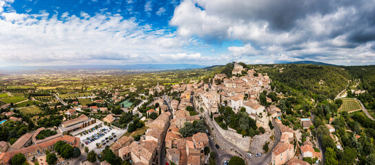 Village of Bonnieux showcasing architecture and serene landscapes, Provence, Luberon, France. Stunning views of Bonnieux medieval village surrounded by lush greenery and hills in Provence.