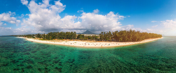 Beautiful Mauritius Island with gorgeous beach Flic en Flac, aerial view from drone. Mauritius, Black River, Flic-en-Flac view of oceanside village beach and luxurious hotel in summer.