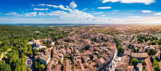 Overlooking Uzes in Gard, France, this scene captures the charming stone buildings and rooftops of the city. Scenic view of Uzes city in Gard, France showcasing historic architecture. Gard, France.