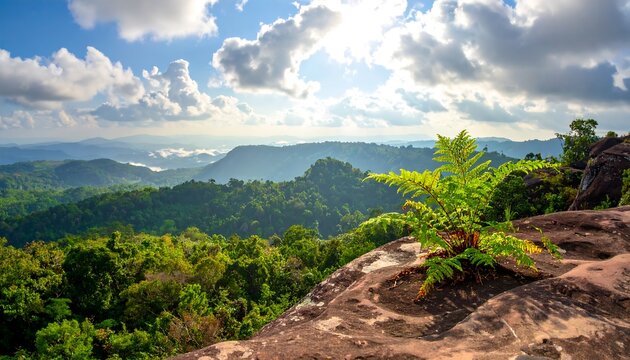 A vibrant vista showcases lush green hills under a bright blue sky dotted with puffy white clouds, with rock in foreground