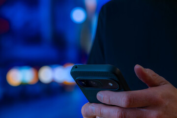 Hand Holding Smartphone In Night City Lights, Checking Messages And Notifications On The Go, Mobile Internet Communication For Urban Travel, Navigation And Social Media