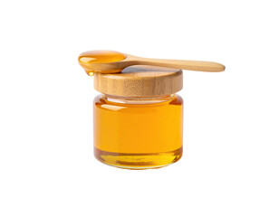Close-up of golden liquid dripping from a wooden spoon resting on a honey jar