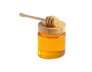 A small jar filled with golden liquid, topped with a wooden lid and dipper