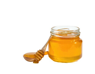 Close-up of a small glass jar filled with golden, viscous liquid and a honey dipper