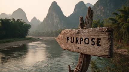 A weathered sign pointing towards purpose along a tranquil river landscape