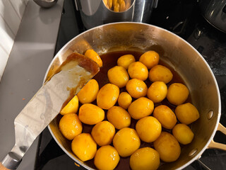 Brown caramelized potatoes frying in pan for Christmas Denmark