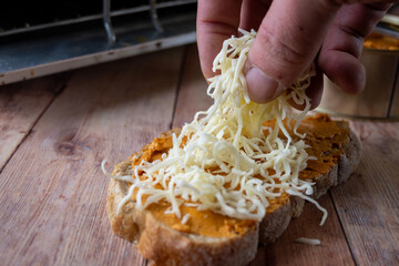 Cheese Being Added to Homemade Sandwich