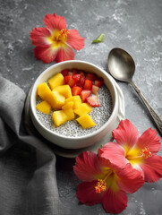 Chia seed pudding topped with mango and strawberries in bowl  