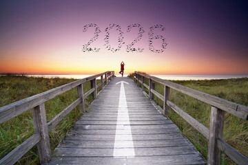 person in a yoga pose on a wooden pier with arrow to 2026