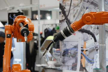 Industrial robotic arms with interchangeable end effectors performing automated welding, cutting, painting, and assembly tasks in advanced manufacturing environments