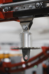 Suspension trolley unit on linear guide with rollers, featuring mounting eye lug below for attaching loads in material handling and automation systems