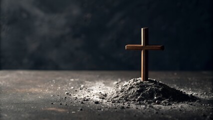 A Simple Wooden Cross Stands Tall on a Small Pile of Ash Against a Dark Textured Background