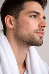 Obraz premium Handsome young man in white bathrobe profile view for spa and self care concepts