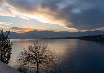 Sunset over the mountains and beautiful reflection on the sea