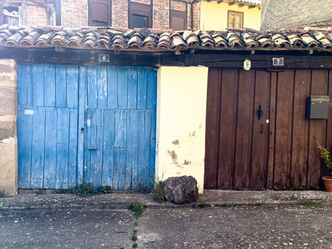 Colorful wooden doors on rustic houses in Valleespinos de Cervera