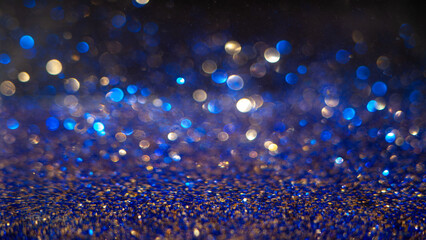 Colorful bokeh lights create a unique effect on a dark background with blue tones