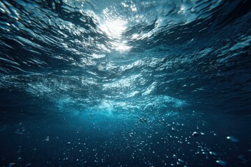 Obraz premium Underwater view of deep blue water. Sunlight beams through the surface