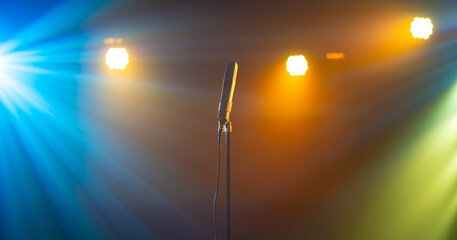 Microphone on color bright lights stage