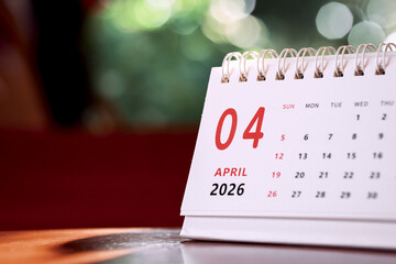 Calendar page of April 2026 on desk, with copy space. monthly planning concept, important schedules, meetings, and appointments.