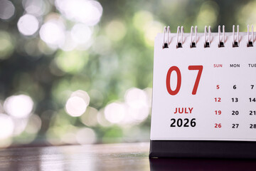 Calendar page of July 2026 on desk, with copy space. monthly planning concept, important schedules, meetings, and appointments.