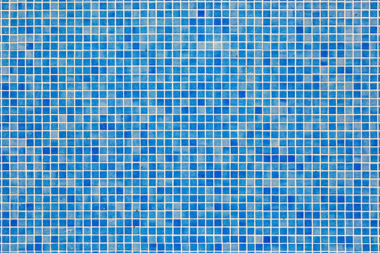 background of blue small tiles at a swimming pool
