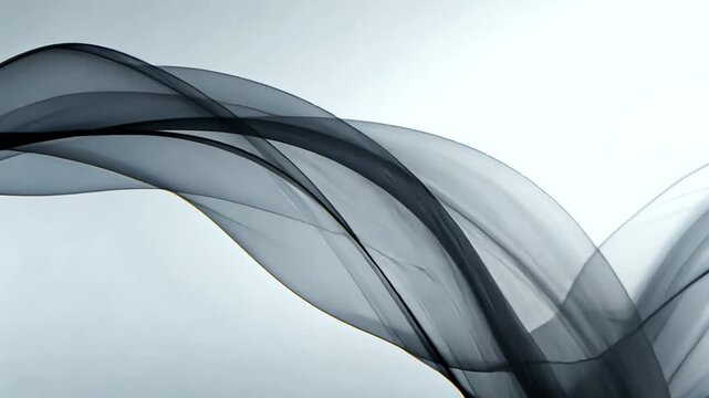 Flowing translucent fabric in shades of black and gray, with a smooth and elegant wave design