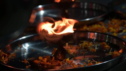 Lightened diya lamps with flower petals in a thali after ganga aarti in Rishikesh, India.