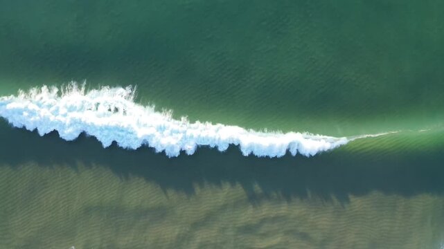 drone footage of waves crashing in portugal caparica