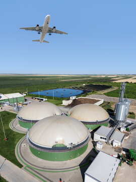 An airplane flies over a biogas plant. A symbol of decarbonization and carbon neutrality in transport.