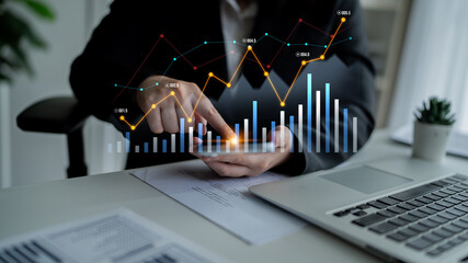 Business professional engages with digital data analysis, highlighting trends and metrics in a modern office setting, emphasizing financial performance and strategic insights. Scalp