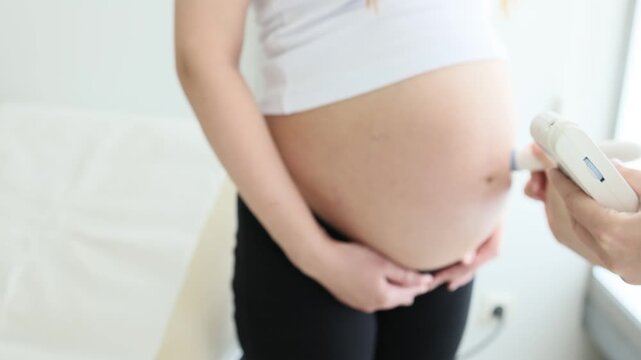 Close up of ultrasound scan of pregnant woman in third trimester in medical clinic