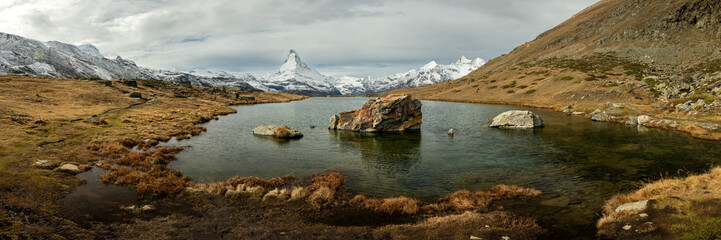 Rock Islands In the Middle Of Stallisee With Snow Covered Matterhorn In The Distance © kellyvandellen
