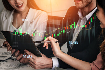 A business team collaborates in a modern office, analyzing financial data on a tablet. Stock market graphs highlight trends and investment insights, showcasing professionalism and teamwork. Scalp