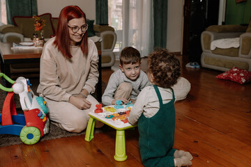 Mother and Son Playing with Toys on the Floor