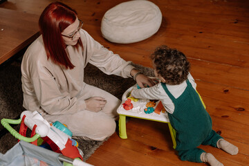 Mother and Toddler Sharing a Playful Moment with Toys
