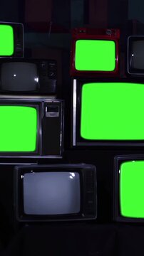 Stack of Retro Television Sets Turning Off with Green Screens, Vintage CRT Screens for Chroma Key Replacement - 4K Vertical