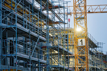 Sylt island scaffolding with yellow crane and sign number one.
