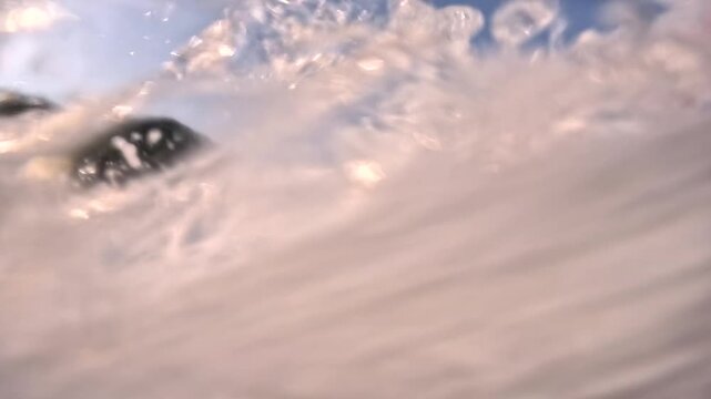 Waves crashing on shore at an ocean beach during late afternoon hours